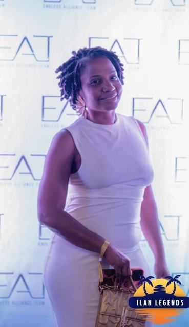 A guest in white posing at the photo booth