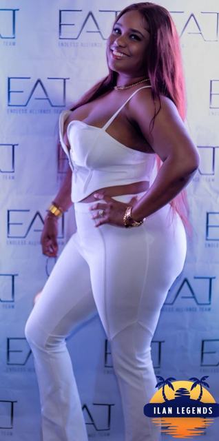 A guest in a white two-piece at the photo booth