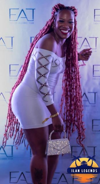 A guest with long braids posing at the photo booth