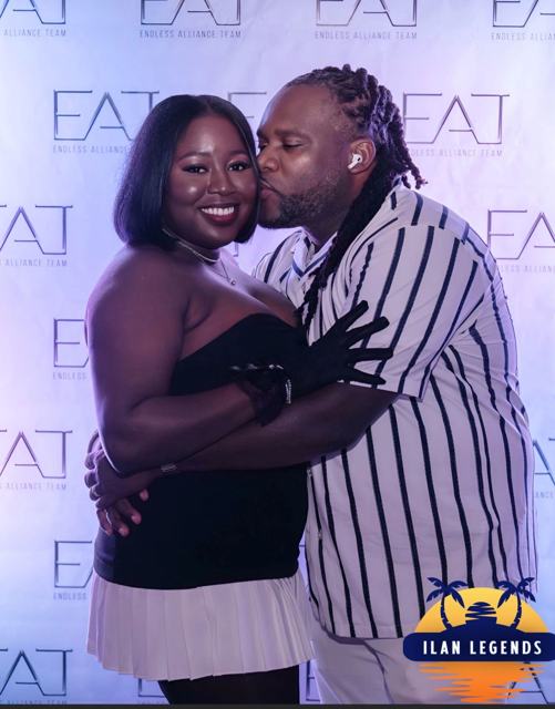 A couple sharing a kiss at the photo booth
