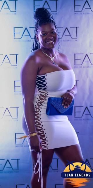 A guest in a white lace-up dress at the photo booth