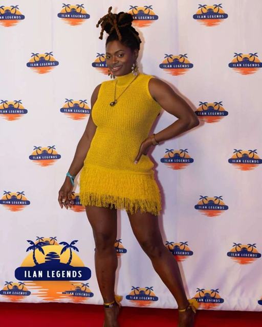 A guest in a yellow fringe dress on the red carpet