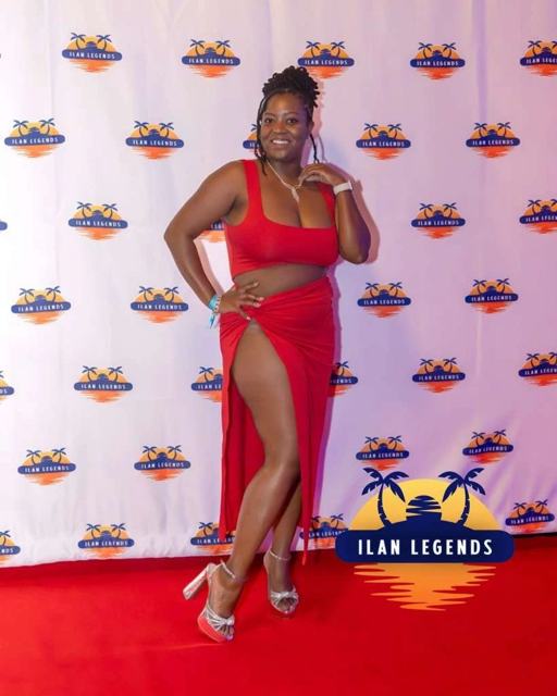 A guest in a red dress on the red carpet
