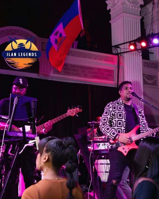 The band on stage with a Haitian flag
