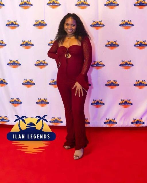 A guest in burgundy on the red carpet