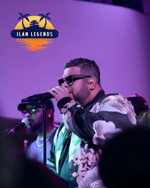 A singer in sunglasses performing