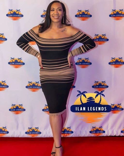 A guest in a striped dress on the red carpet