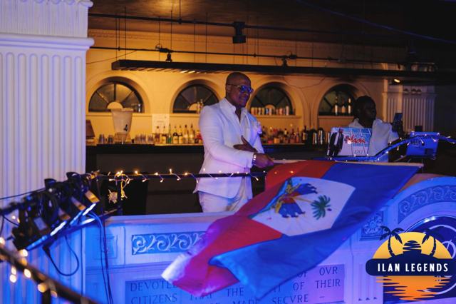 The DJ booth draped in a Haitian flag