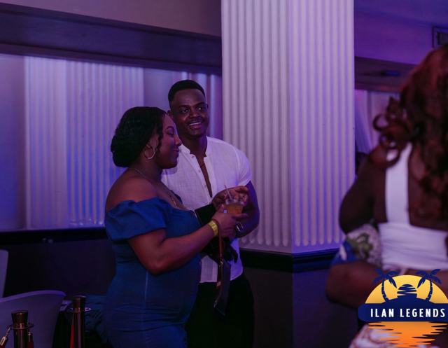 A couple dancing, she in a blue dress