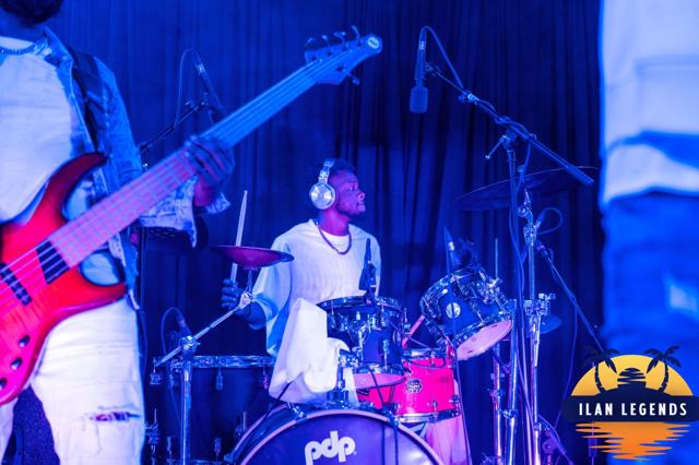 The guitarist and drummer under blue lights