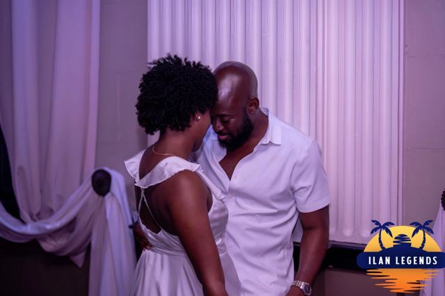 A couple slow dancing by the curtains