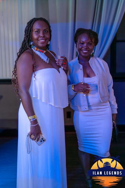 Two women in white posing