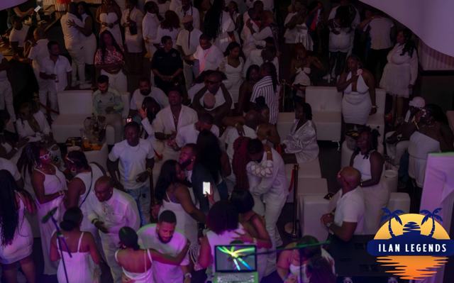 A full room of guests in white